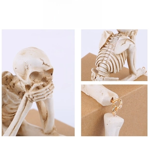 Close-up of resin skeleton joints with gold metal rings and aged texture detail