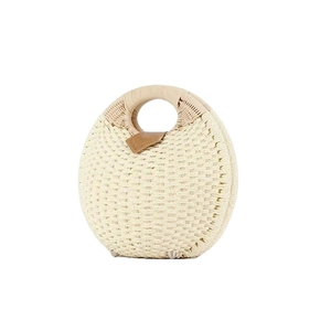 Chic cream straw handbag with round integrated handle and brown leather trim detailing