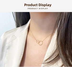 Macro detail of interlocking gold double ring pendant on delicate titanium chain