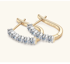 Detailed macro view of S925 hallmark on two-tone gold and silver moissanite hoop earrings