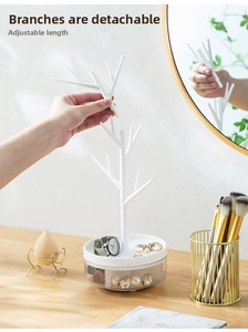 Detail showing the detachable white tree branch jewelry rack and organizer tray base