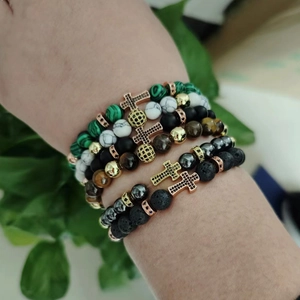 Stackable beaded cross bracelet set featuring tiger eye, lava stone and marble beads