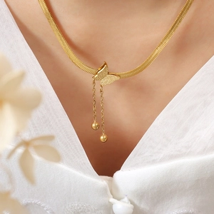 Elegant gold snake chain necklace with matte butterfly pendant and long tassels on neck