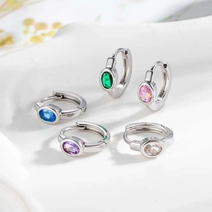 Five small geometric earring hoops with colorful zircons set in polished silver metal