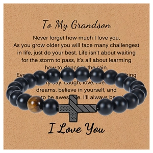 Detail of American flag cross bracelet with black matte beads and tiger eye stone