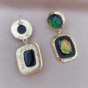 Detailed close-up showing the gold-plated wavy texture and colorful resin inlay of earrings