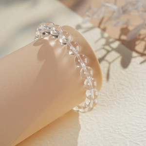 Macro shot of minimalist clear quartz beaded bracelet with polished round crystal beads