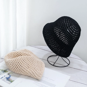 Detail of hollow-out knitted crochet bucket hats in black and beige for summer