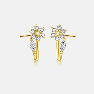 Detail of golden flower stud earrings with crystal petals and marquise drop stones
