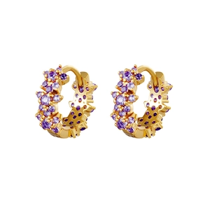 Macro detail of gold-plated hoop earrings with pave-set purple zircon floral accents