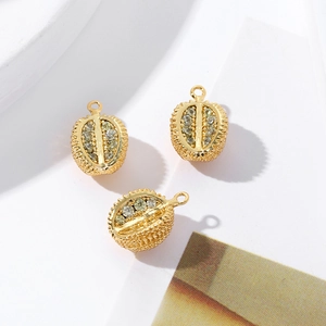 Macro detail of 18K gold-plated durian pendants with sparkling cubic zirconia stones