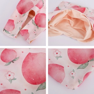 Pink velvet wrist bag with peach print, showing interior lining and fabric texture details
