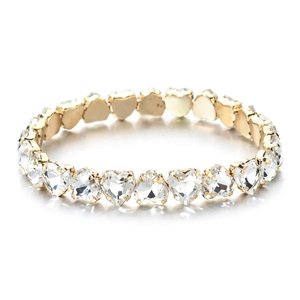 Detail of heart-shaped zircon stones in gold-plated three-prong settings on the bracelet