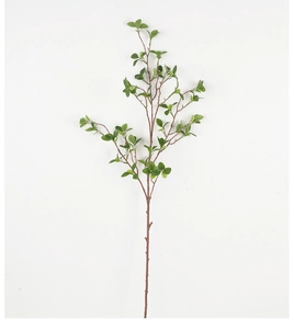 Close-up of lifelike green Milan leaves on a brown branch for indoor home decoration