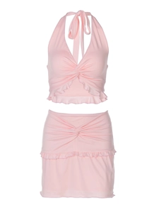 Detail of pink two-piece set featuring a halter knot top and ruffled mini skirt