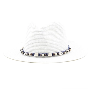 Detail of white Panama hat with blue rope band featuring sea shells and brown wooden beads