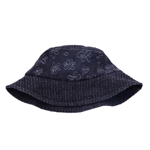 Detailed view of dark denim bucket hat featuring white floral prints and stitched wide brim