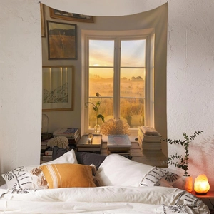 Detail of bohemian tapestry featuring sunset window scenery above bedroom bed