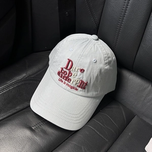 Detailed view of Dare to be different 3D embroidery on light gray washed cotton cap