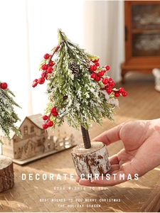Close-up of 24cm mini Christmas tree with snowy pine needles, red berries and wood base