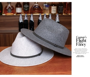 Close-up of retro fedora hats in light and dark grey wool felt with metal stud hatband