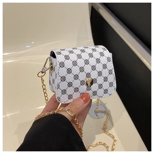 Close-up of white clover pattern mini bag with gold chain strap and metal button detail