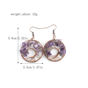 Detail view of handmade Tree of Life earrings with purple amethyst and white crystals
