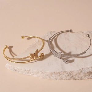 Double-layered gold and silver butterfly clover open bangles with sparkling zircon stones