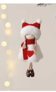 Detail of plush angel girl doll with red scarf and white dress hanging on Christmas tree