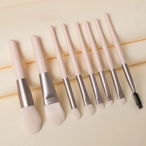 9-piece mini makeup brush set with beige handles and soft synthetic bristles in a pouch