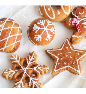 Detailed close-up of gingerbread man and star ornaments with snowy frosting textures