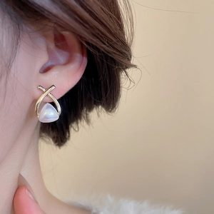 Detailed view of elegant gold-plated ear studs featuring a unique triangle pearl design