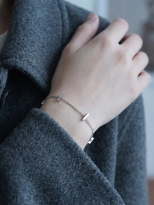 Macro view of minimalist silver chain bracelet with geometric rectangular metal bars