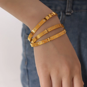Elegant 18K gold plated titanium steel bracelet with zircon inlaid star patterns