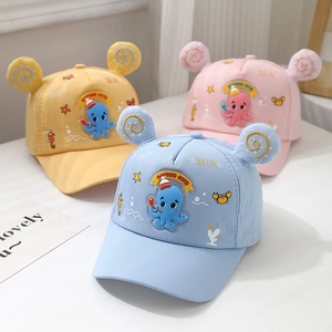 Detailed view of kids baseball caps in yellow, pink and blue with octopus patterns