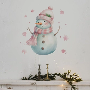 Detail of watercolor snowman wall decal with pink hat over a cozy decorated fireplace