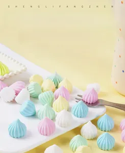 Macro view of colorful spiral pagoda sugar models arranged on a white ceramic plate