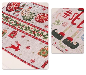 Detail van de gebreide textuur van de kerstplacemat met rendier- en hulstpatronen