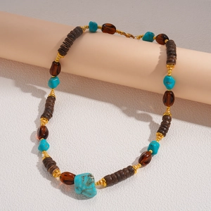Detail of bohemian beaded necklace with turquoise stones and vintage amber accents