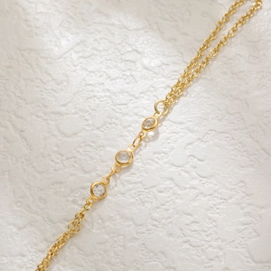 Close-up of gold star butterfly bracelet with sparkling zircon crystals in double chain