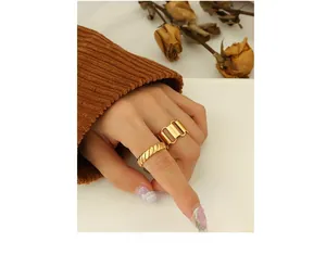 Detailed shot of two-piece gold plated geometric hollow ring and twisted rope band