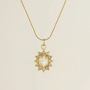Macro detail of 18K gold stainless steel sunflower necklace with oval zircon centerpiece