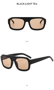Detail view of square black frames and light tea lenses on stylish oversized sunglasses