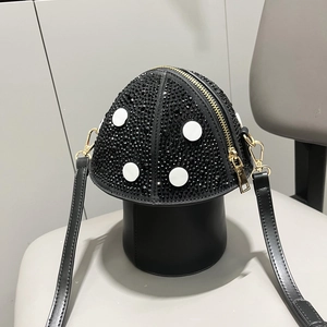 Macro shot of rhinestone mushroom shoulder bag with black crystals and gold zipper