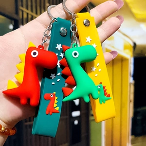 Cute cartoon silicone dinosaur keychain in red and green with matching star wrist strap