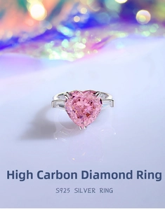 Macro shot of S925 silver ring featuring heart-shaped pink stone and side trapezoid gems