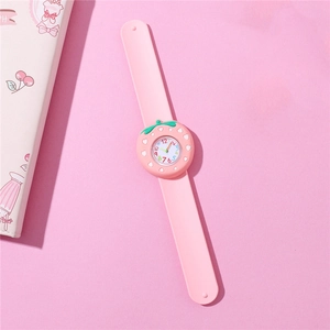 Close-up of pink strawberry cartoon kids slap watch with silicone strap on pink background