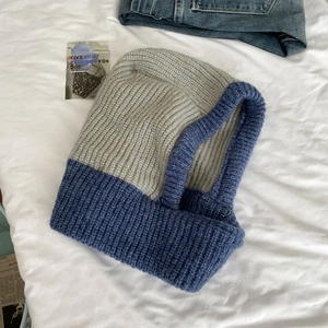 Detailed knit texture of blue and gray balaclava hood scarf for winter protection