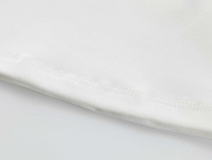Detail of double-needle stitching on the hem of a white elastic athletic T-shirt