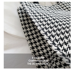 Close-up of black and white houndstooth fabric texture showing fine weaving details